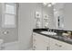 Well-lit bathroom vanity with sleek fixtures, granite counter, and tiled floors at 45 Ocean Point Dr, Isle of Palms, SC 29451