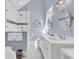 Bright bathroom with double sinks, oval mirrors, walk-in shower and tile flooring at 45 Ocean Point Dr, Isle of Palms, SC 29451
