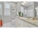 Bright bathroom with large mirror, decorative lights, and shower with curtain at 45 Ocean Point Dr, Isle of Palms, SC 29451