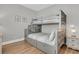 Bedroom featuring a bunk bed with drawers, hardwood floors, and neutral paint at 45 Ocean Point Dr, Isle of Palms, SC 29451