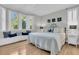 Bright bedroom features a king bed, hardwood floors, and bay window with bench seat at 45 Ocean Point Dr, Isle of Palms, SC 29451