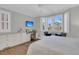 Relaxing bedroom with large windows, a built-in desk, and a king-size bed at 45 Ocean Point Dr, Isle of Palms, SC 29451