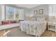 Inviting bedroom with a large window seat and colorful coral themed bedding at 45 Ocean Point Dr, Isle of Palms, SC 29451