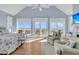 Bedroom featuring high ceilings, water views, and sitting area with fireplace at 45 Ocean Point Dr, Isle of Palms, SC 29451