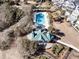 Aerial shot showcasing a large community pool with ample lounge chairs, set amidst lush landscaping and mature trees at 45 Ocean Point Dr, Isle of Palms, SC 29451