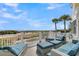 Outdoor deck features lounge seating with plush cushions and ocean views at 45 Ocean Point Dr, Isle of Palms, SC 29451