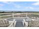 Outdoor deck featuring chairs and beautiful views of the beach and golf course at 45 Ocean Point Dr, Isle of Palms, SC 29451