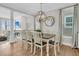 Elegant dining area with chandelier lighting, seating for six, and beach views at 45 Ocean Point Dr, Isle of Palms, SC 29451