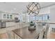 Elegant dining room featuring designer lighting, and open views of the ocean and kitchen at 45 Ocean Point Dr, Isle of Palms, SC 29451