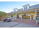 Inviting clubhouse exterior featuring a golf cart, well-manicured landscaping, and a welcoming entrance for residents at 45 Ocean Point Dr, Isle of Palms, SC 29451