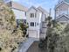 Beautiful white home with a garage and stairs leading to the front door surrounded by lush landscaping at 45 Ocean Point Dr, Isle of Palms, SC 29451
