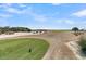 Scenic golf course with lush green grass and sandy dunes under a clear blue sky, perfect for outdoor recreation at 45 Ocean Point Dr, Isle of Palms, SC 29451
