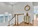 Upstairs landing with wooden railing, nautical themed decor, and abundant natural light at 45 Ocean Point Dr, Isle of Palms, SC 29451