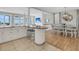 Open-concept living space with a large island bar, dining area, and views of the ocean at 45 Ocean Point Dr, Isle of Palms, SC 29451