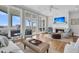Cozy living room with a fireplace, large windows offering scenic ocean views, and comfortable seating at 45 Ocean Point Dr, Isle of Palms, SC 29451