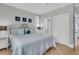 Cozy bedroom with an iron frame bed, bedside tables, and a closet at 45 Ocean Point Dr, Isle of Palms, SC 29451