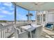 Outdoor patio with a dining table and chairs overlooking a scenic view of the ocean at 45 Ocean Point Dr, Isle of Palms, SC 29451