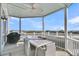 Outdoor patio with a dining table and chairs overlooking a scenic view of the ocean at 45 Ocean Point Dr, Isle of Palms, SC 29451