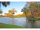 Picturesque pond on a golf course, with trees and a water fountain, creating a scenic and tranquil atmosphere at 45 Ocean Point Dr, Isle of Palms, SC 29451