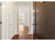 Inviting entryway with dark wood door, view into the home, white columns, and gleaming hardwood floors at 498 Albemarle Rd # 306, Charleston, SC 29407
