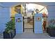Grand entrance to The Albemarle featuring secure gate, landscaping, and a welcoming entryway at 498 Albemarle Rd # 306, Charleston, SC 29407