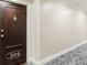 Hallway view showing unit 306 with a dark wooden door and decorative knocker and patterned carpet at 498 Albemarle Rd # 306, Charleston, SC 29407