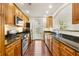 Charming kitchen featuring granite countertops, stainless steel appliances, and ample wooden cabinetry at 498 Albemarle Rd # 306, Charleston, SC 29407
