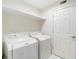 Laundry room includes a washer, dryer, and built-in shelving at 498 Albemarle Rd # 306, Charleston, SC 29407