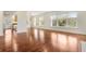Bright and airy living room featuring gleaming hardwood floors and large windows with tree views at 498 Albemarle Rd # 306, Charleston, SC 29407