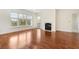 Open living room featuring hardwood floors, large windows, neutral paint, and a cozy fireplace at 498 Albemarle Rd # 306, Charleston, SC 29407