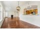 Open-concept living room with hardwood floors, fireplace, large window, and pass-through to kitchen at 498 Albemarle Rd # 306, Charleston, SC 29407