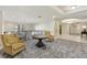 A modern lobby with stylish chairs, a table, and unique flooring, provides a welcoming atmosphere at 498 Albemarle Rd # 306, Charleston, SC 29407