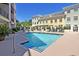A clear blue pool in a courtyard setting, surrounded by lush landscaping and lounge seating at 498 Albemarle Rd # 306, Charleston, SC 29407