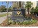 Community sign with address number above community logo and sign with flowers at 498 Albemarle Rd # 306, Charleston, SC 29407