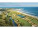 Breathtaking aerial view of a lush golf course, beach, and ocean at 5541 Green Dolphin Way, Kiawah Island, SC 29455