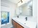Modern bathroom featuring dual sinks, sleek black fixtures, and an exterior view at 5541 Green Dolphin Way, Kiawah Island, SC 29455