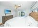 Relaxing bedroom with a mounted TV and picturesque views of the community pond at 5541 Green Dolphin Way, Kiawah Island, SC 29455