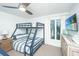 Comfortable bedroom with a bunk bed, side table, and mounted TV at 5541 Green Dolphin Way, Kiawah Island, SC 29455