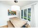 Bright dining area featuring a wood table, unique art, and a scenic outdoor view at 5541 Green Dolphin Way, Kiawah Island, SC 29455