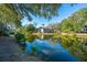Beautiful view of homes set amidst lush greenery reflecting in the calm lake waters at 5541 Green Dolphin Way, Kiawah Island, SC 29455