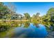 Scenic community buildings reflected in the calm lake waters, surrounded by lush greenery at 5541 Green Dolphin Way, Kiawah Island, SC 29455