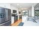 Bright kitchen featuring white cabinets, stainless appliances, stone countertops, and view of the dining area at 5541 Green Dolphin Way, Kiawah Island, SC 29455