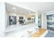 Bright kitchen featuring white cabinets, stainless appliances, stone countertops, and seating at the counter at 5541 Green Dolphin Way, Kiawah Island, SC 29455
