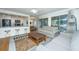 Cozy living room with white sofas, a ceiling fan, a coffee table, and a view of the outside at 5541 Green Dolphin Way, Kiawah Island, SC 29455