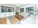 Living room with comfortable seating, access to kitchen, and a view of a wooded area at 5541 Green Dolphin Way, Kiawah Island, SC 29455