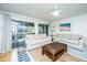 Bright living room features comfortable seating and large windows with a beautiful outdoor view at 5541 Green Dolphin Way, Kiawah Island, SC 29455