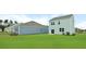 A well-maintained backyard featuring a lush green lawn and a view of the home's exterior at 7014 Deanston Dr, Ravenel, SC 29470