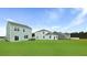 A well-maintained backyard featuring a lush green lawn and a view of the home's exterior at 7014 Deanston Dr, Ravenel, SC 29470
