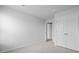 A neutral bedroom has carpet, white walls, closet, and door at 7014 Deanston Dr, Ravenel, SC 29470