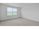 A spacious bedroom featuring neutral walls, carpet, and natural light at 7014 Deanston Dr, Ravenel, SC 29470